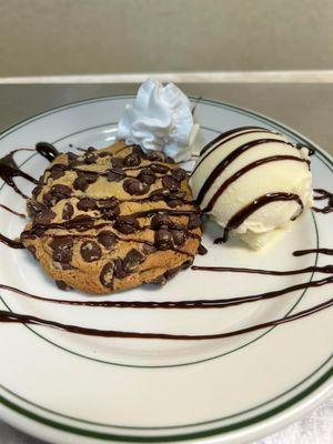 warm extra-large, overloaded chocolate chip cookie with a side of vanilla ice cream, OH MY!