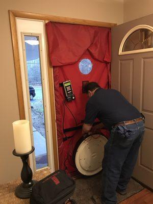 Attaching a blower to the front door to determine how much air is coming in from cracks