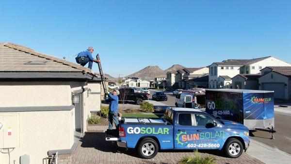 Our installers getting the solar panels up onto the roof for install.