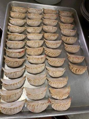 Freshly prepared pot stickers await the next customer's order. Steamed or fried, they're YUMMY!