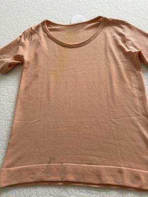 Shirt with discoloration and stains.