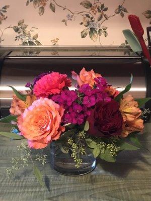 Picture of bouquet sitting on countertop with very few flowers.