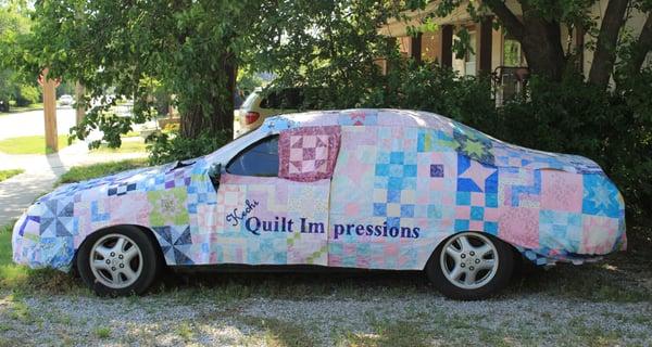 Quilted car cover made for the Miracle Block Project. Quilt blocks are make by quilters from all around Kansas...