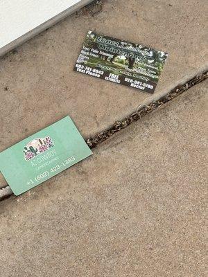 The business cards they took off of my door and threw on the ground in front of my garage!