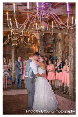 The first dance in the event barn with just the chandeliers for lighting