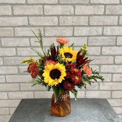 Sunny Autumn flower arrangement of sunflowers and long-lasting mums, carnations and alstromeria.