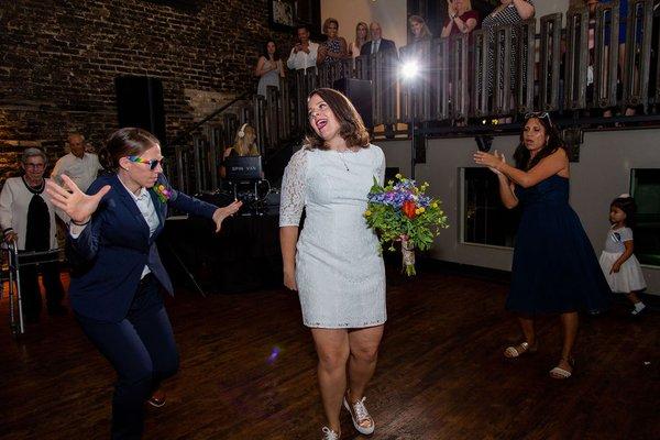 The brides on the dance floor.  Photo by Cage + Aquarium.