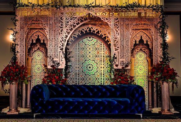 Moroccan palace backdrop for a Mehndi party.