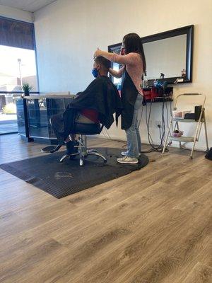 Nice hardwood floors. Toni cutting hair.