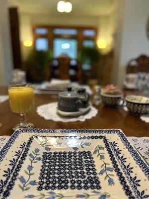 A place setting at the main dining room facing the living room with fire place.