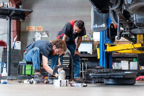 Our expert mechanics collaborating to deliver top-quality repairs in our fully-equipped auto repair shop.