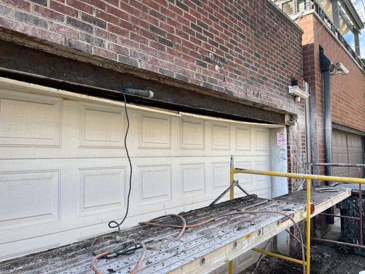 Exposed damaged steel lintel - I Beam - ready for repairs- all masonry bricks are being recycled for re-use