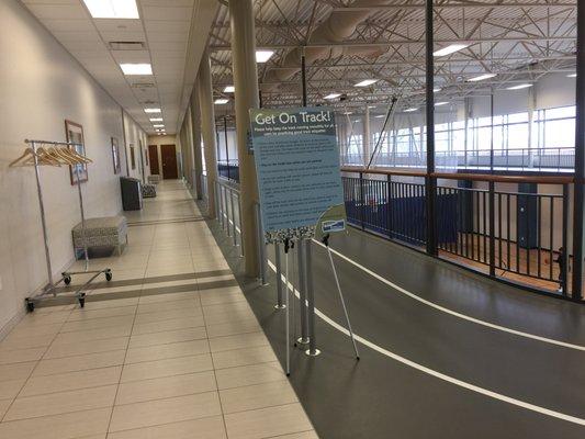 Upstairs track overlooking the basketball courts. Seating areas next to track.