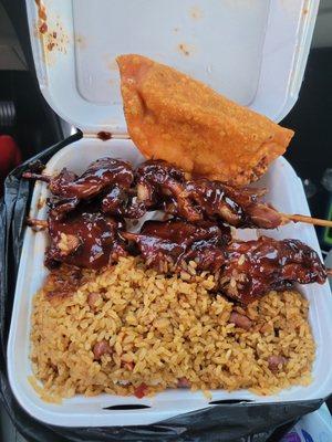 BBQ Pinchos and rice and a beef and cheese pastelito.