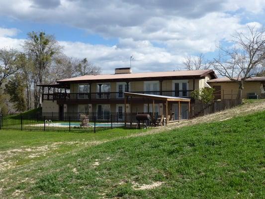 This is the backside of the house, showing both levels and pool.