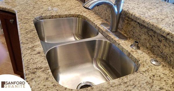 Giallo Ornamental Countertop with a Stainless Steel Double Bowl Sink installed by the Sanford Granite Team in New Smyrna.