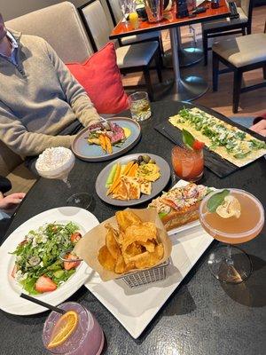 Lobster roll, lamb, flatbread, salad, hummus, and seasonal cocktails