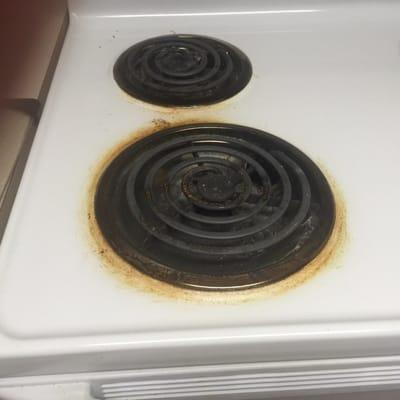 Old dated stove with metal burners that don't heat up all the way and that yellow build up that's won't go away no matter how hard I scrub.