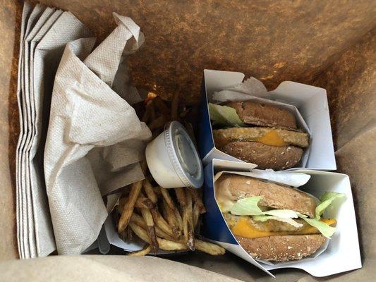 Two Veggie Burgers with fries