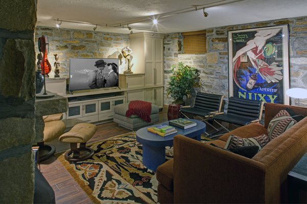 An unused basement with stone walls became a stylish and colorful family room.