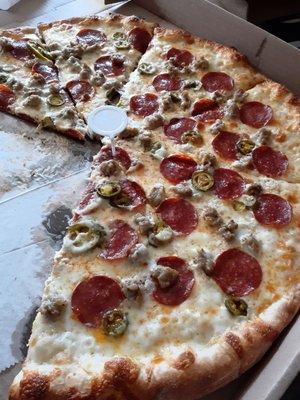 This is a white pizza with ricotta cheese sauce. It also has pepperoni and jalapeno and let's not forget the sausage.