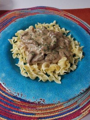 Beef tips over noodles