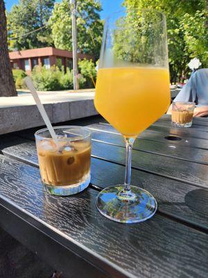 Espresso with cream over ice and a Mimosa.