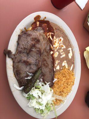 Carne asada with an enchilada, it's underneath, you can't really see it, but it's yummy.