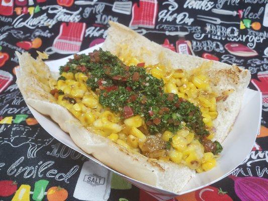 Choripan, this is like a sandwich but better. Toasted bread, grilled chorizo, fried corn and melted Mexican cheese topped with chimichurri