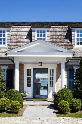 The front door of this shingle-style gambrel home on Martha's Vineyard opens to reveal a direct view to Edgartown Harbor.