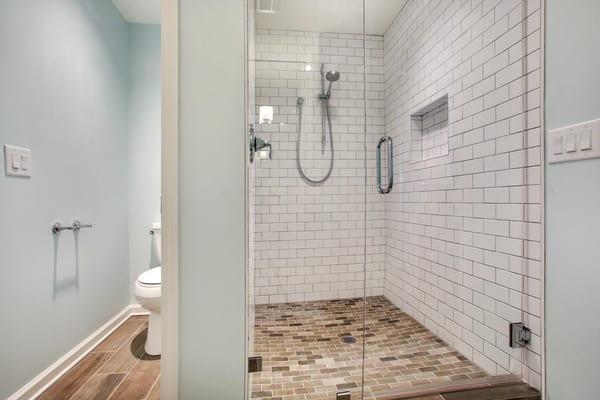 Beautiful Walk In Shower with subway tile and enclosed water closet.