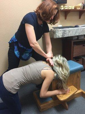 Dr. Nicole giving one of our patients an upper-cervical adjustment.