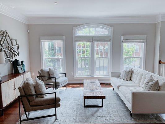 Open and airy living room with custom window shades.