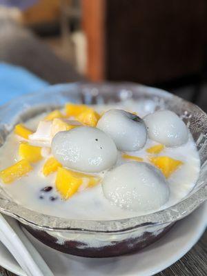 Sesame ball and mango over purple rice