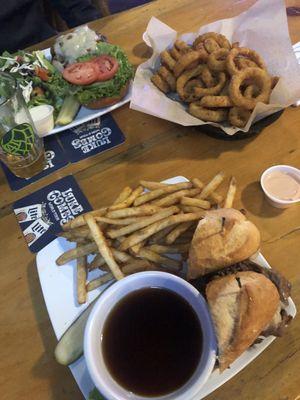 Mushroom Swiss burger with side salad  Onion rings Prime rib dip with fries