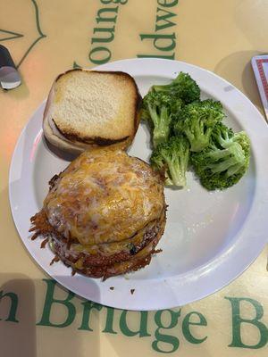 Porkroll sandwich with cheddar on a burger bun.