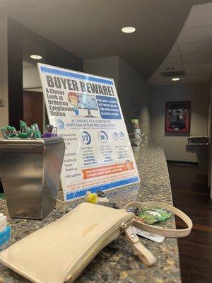 The "Buyer Beware" sign trying to keep people from buying cheaper glasses online and instead buying $400 glasses from the clinic.