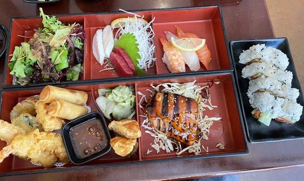 Deluxe Dinner Bento: Mix Tempura, Egg Rolls, Gyoza, Teriyaki Salmon, Nigiri, Sashimi, and Salad! Spicy Tuna Roll upgrade for $2.00!