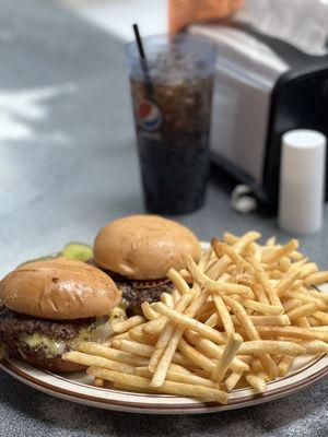 Two double cheeseburgers with bacon, fries and a Pepsi