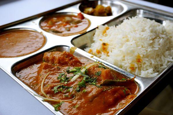 Bombay Fish Masala: filets of fish simmered in a sauce of coconut, tomato, ginger, garlic, spices, curry leaves, mustard seeds ($14.95).