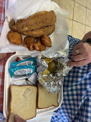 Catfish meal with shrimp and fried okra and baked potato.