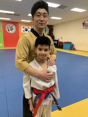 Master Kenny with just promoted red belt Niko