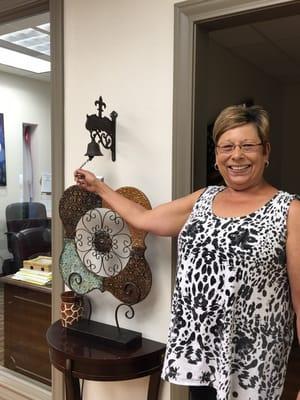 Debbie ringing the bell for another happy home buyer