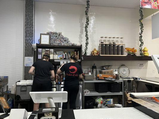 The employees making our strawberry bubble tea.