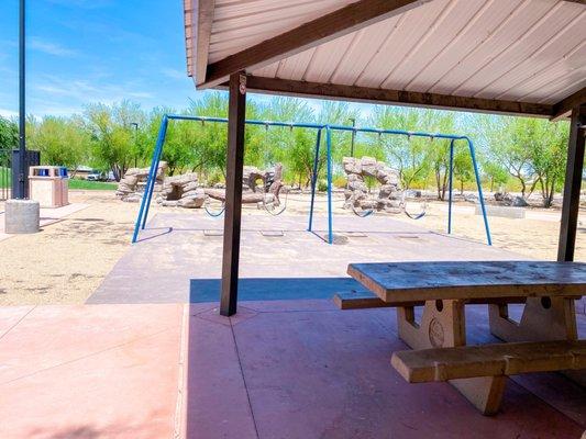 Swing set by covered picnic tables