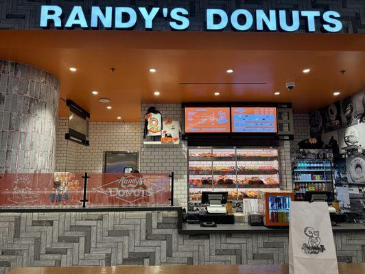 Randy's Donuts inside Resorts World & our bag of chocolate donuts and glazed donuts to go.