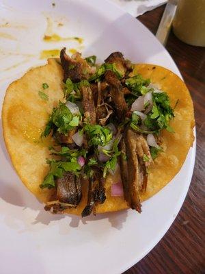 Carnitas in fried corn tortilla