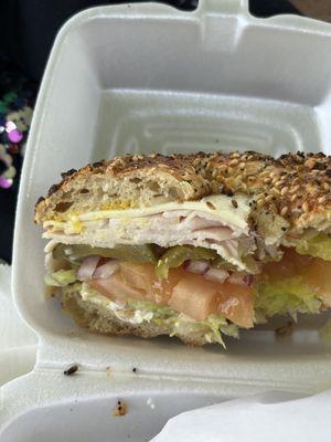 Smoked turkey sandwich on an everything bagel