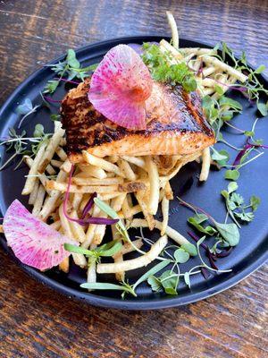 Savor perfection on a plate: Chef's Maple-Glazed Salmon over Curry Fries, a symphony of flavors in every bite.