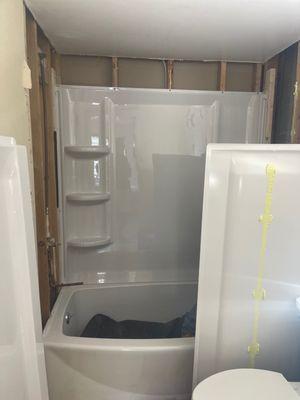 Bath tub and shower combo during installation.